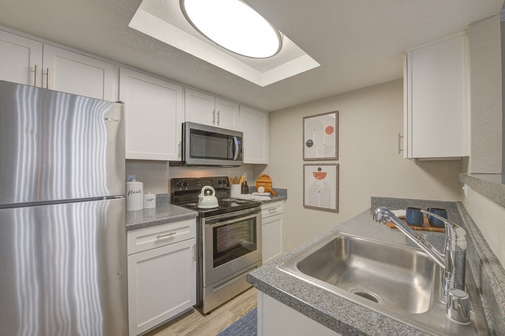 Apartments for Rent in Moreno Valley - Ardella on Chagall - Kitchen with White Cabinets, Speckled Grey Countertops, and Stainless Steel Appliances