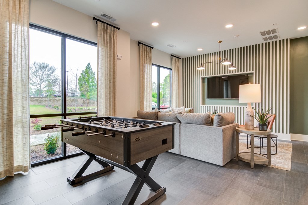 Sky Harbor Apartments in Chamblee, GA photo of a a games room with a foosball table and a couch