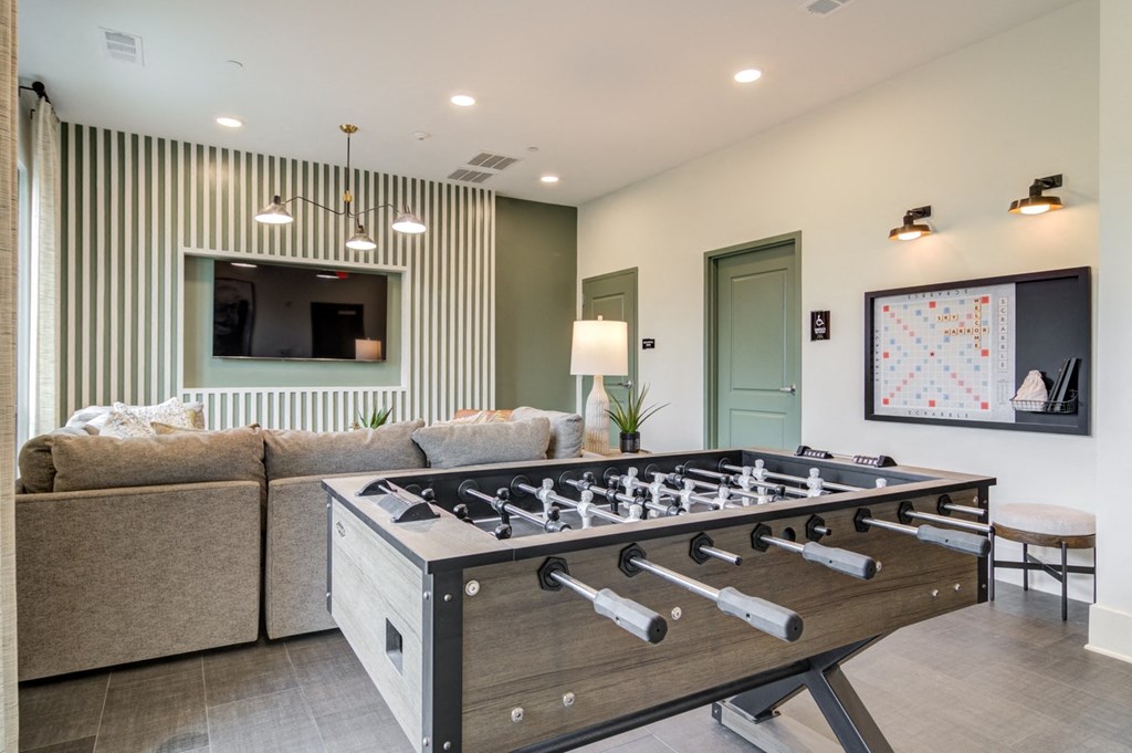Sky Harbor Apartments in Chamblee, GA photo of a a foosball table in a living room with a couch
