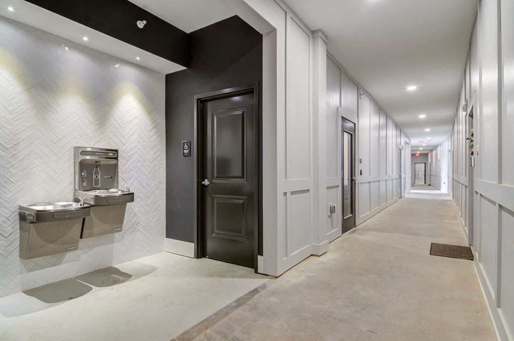 Sky Harbor Apartments in Chamblee, GA photo of a a hallway of elevators and doors in the clubhouse