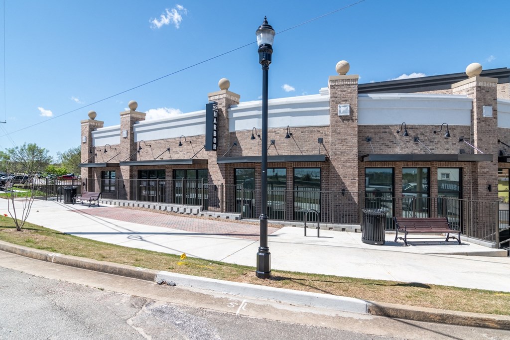 Sky Harbor Apartments in Chamblee, GA photo of a the front of a brick building with a sidewalk and a street light