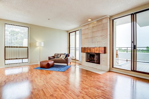 a living room with a fireplace and sliding glass doors