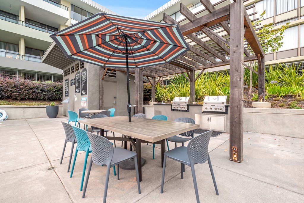 a patio with a table and chairs and an umbrella