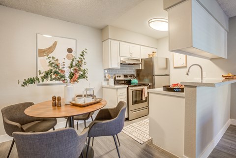 an open kitchen and dining area with a table and chairs