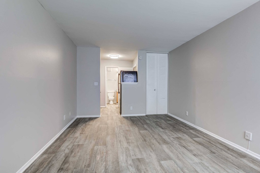 Open-concept and spacious living room and dining area at Somerset Apartments, a pet-friendly community near Charlotte and Huntersville, NC.