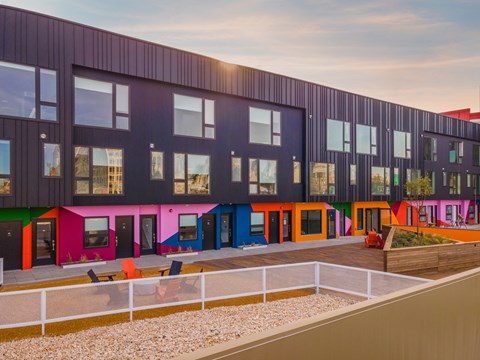 A modern building with colorful doors and windows.