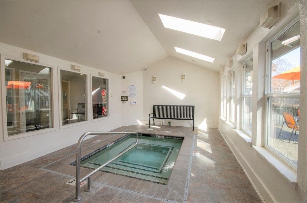 a small pool in the middle of a room with a bench