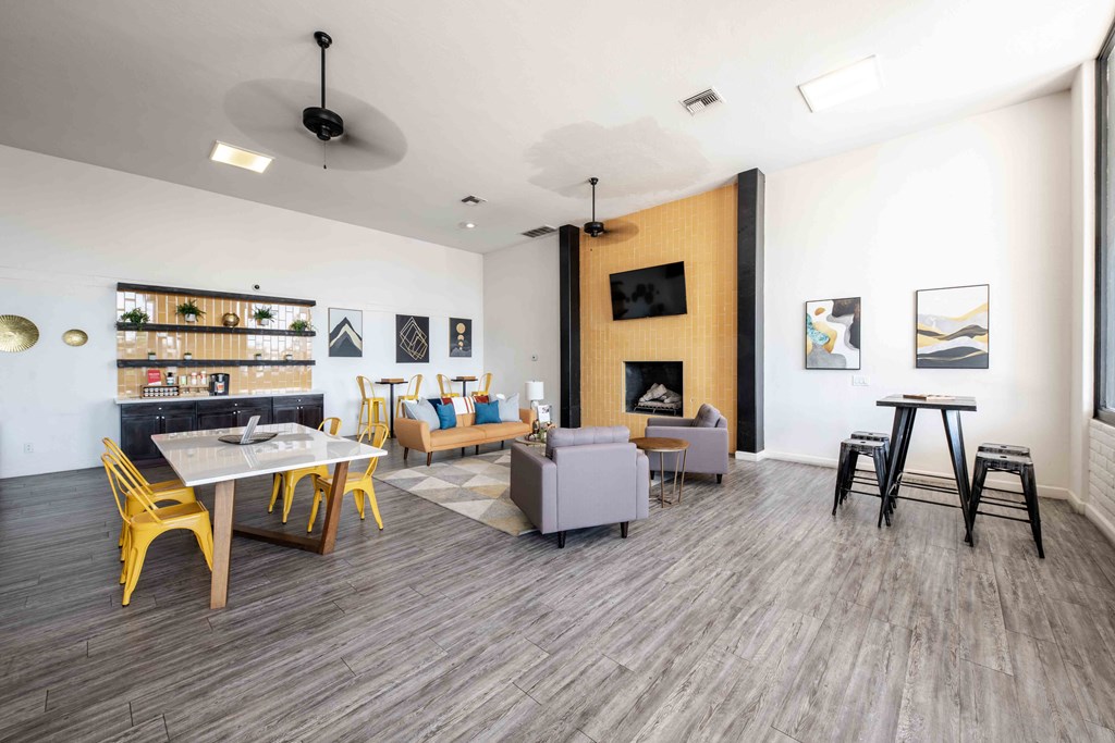 a living room with a table and chairs and a fireplace