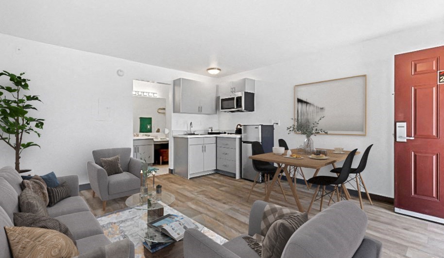 a living room and kitchen with a table and chairs