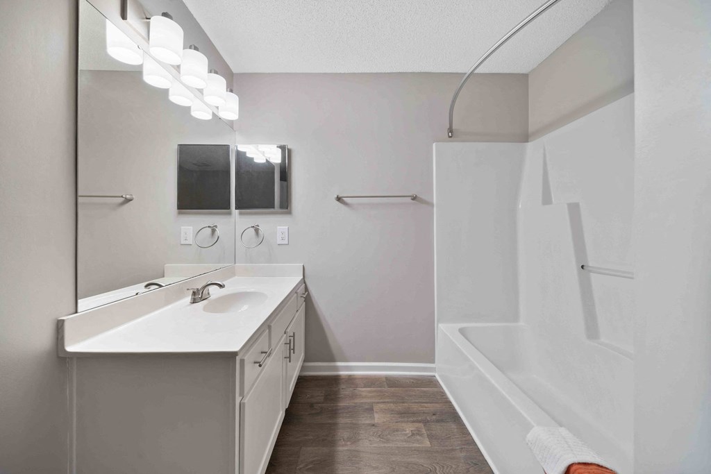 Updated bathroom with large shower and white cabinetry