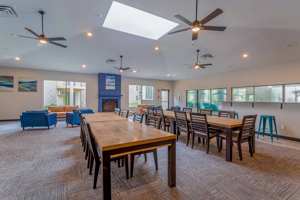 a large dining room with tables and chairs and a fireplace