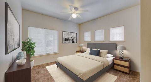 A bedroom with a large bed, a ceiling fan, and a potted plant.