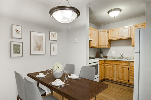 the view of a dining room table and a kitchen