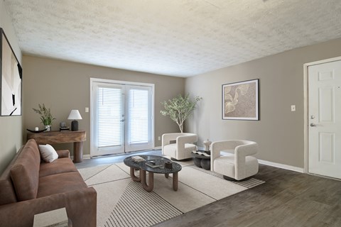 Spacious living room with sleek wood-style plank flooring at Stratford Ridge, a pet-friendly community in Marietta, GA, near Smyrna.
