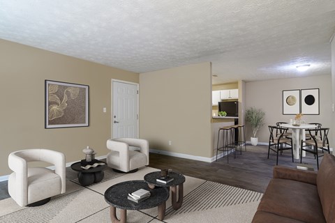 A living room with a brown couch, a coffee table, and a dining table with chairs.