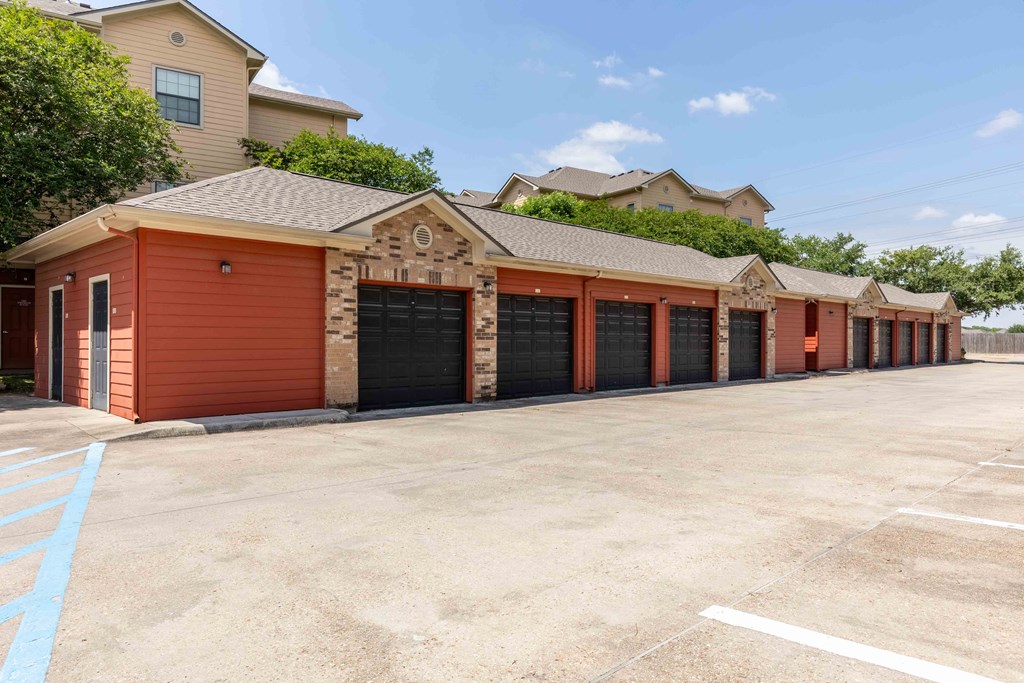 Sugar Mill Apartments in Addis, LA photo of a row of garages at the end of a parking lot