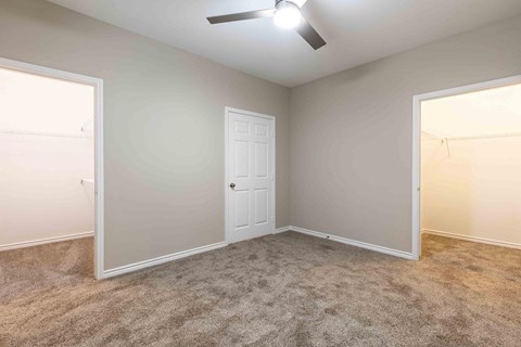 Sugar Mill Apartments in Addis, LA photo of an empty bedroom with a door to a closet
