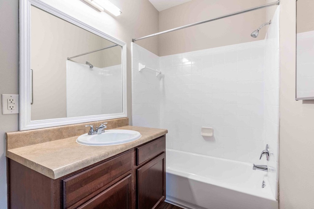 Sugar Mill Apartments in Addis, LA photo of a bathroom with a sink and a shower and a mirror