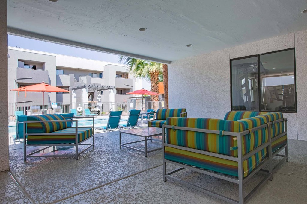 a lobby with chairs and tables and a pool