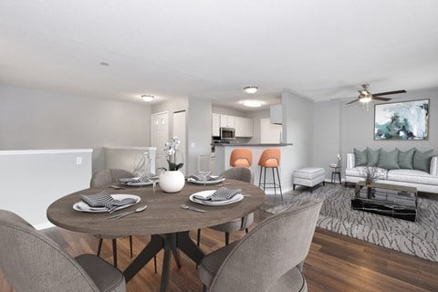 an open living room and dining room with a table and chairs