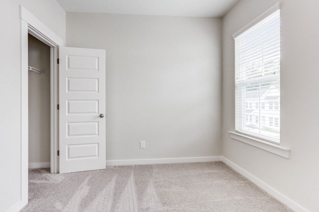 Dog Friendly Townhomes in Park Circle SC - Sumner Village - Well Lit Bedroom with Carpet Flooring, Large Closet, and a Window