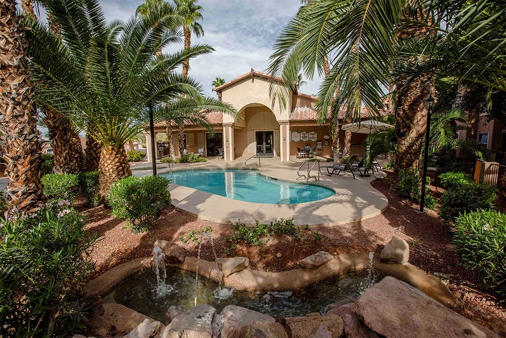 a pool and spa in the backyard of a house
