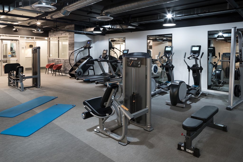 a gym with weights and other exercise equipment in a building