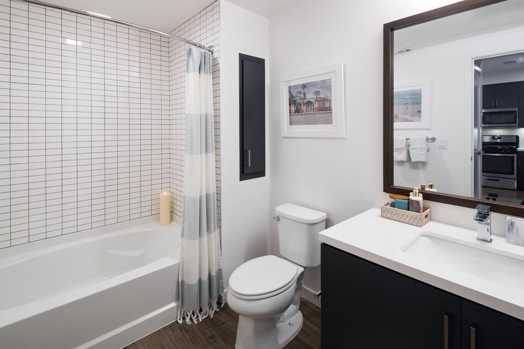 a bathroom with a toilet and a tub and a sink