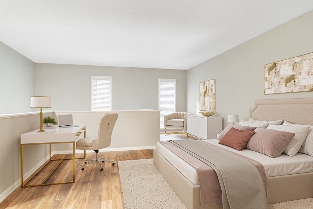 Affinitee at Stone Mountain Apartments photo of a bedroom with a bed and a desk with a chair