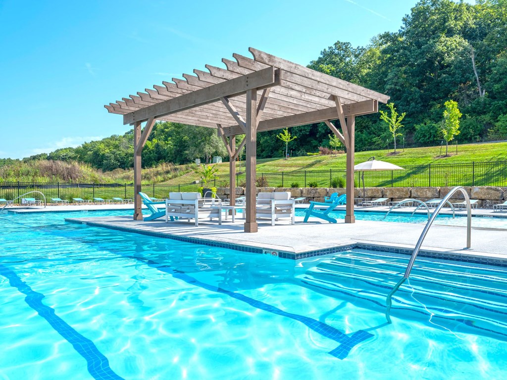 a swimming pool with a pavilion next to a pool