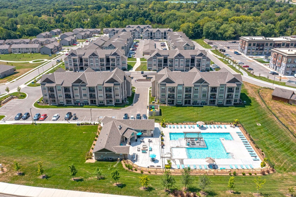 an aerial view of a large building with a swimming pool