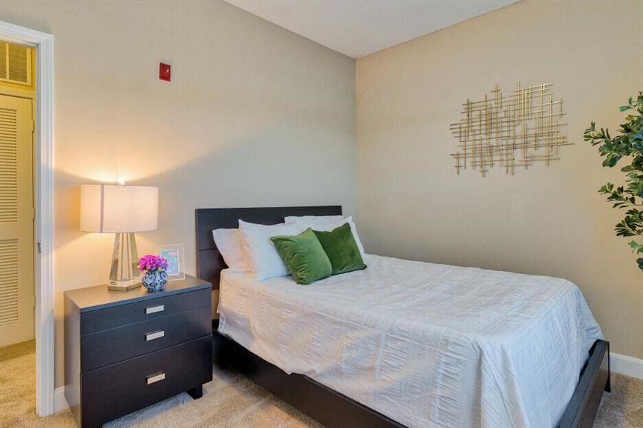 Pet-Friendly Apartments in Oakridge, TN - Centennial Village - Bedroom with bed and furniture