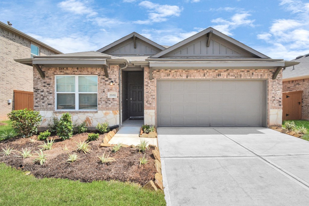 a house with a concrete driveway and a garage door