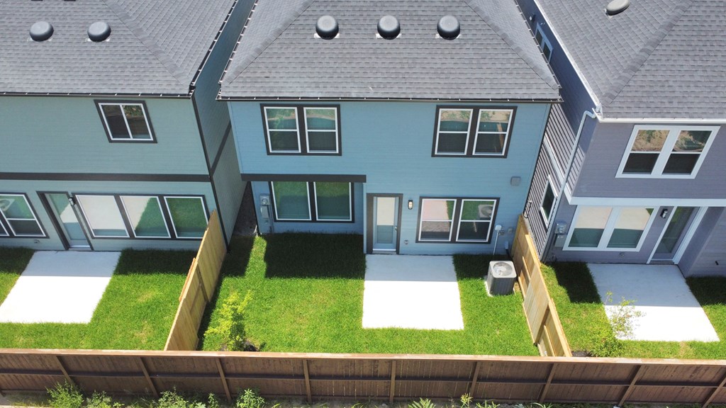 a view of the backyard of a house from above