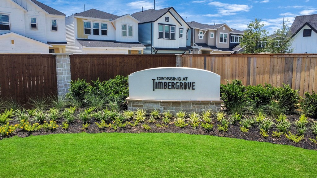 a subdivision sign in front of a row of houses