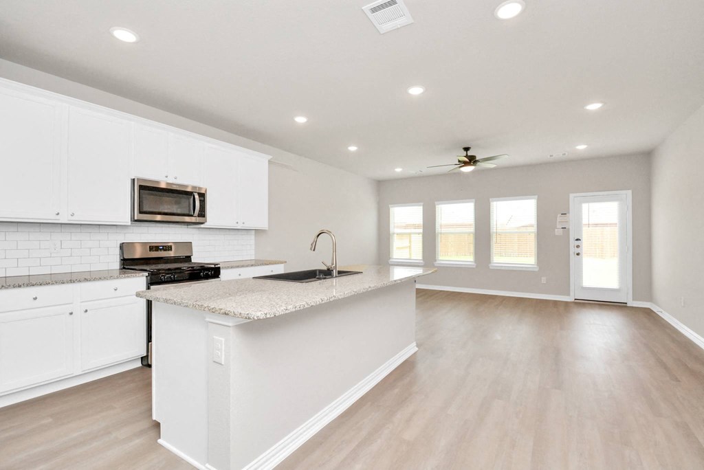 a kitchen with white cabinets and a white counter top