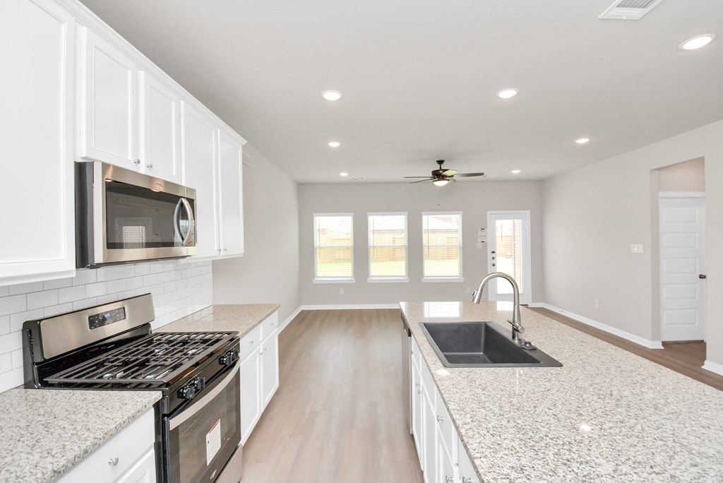 a kitchen with white cabinets and a white counter top