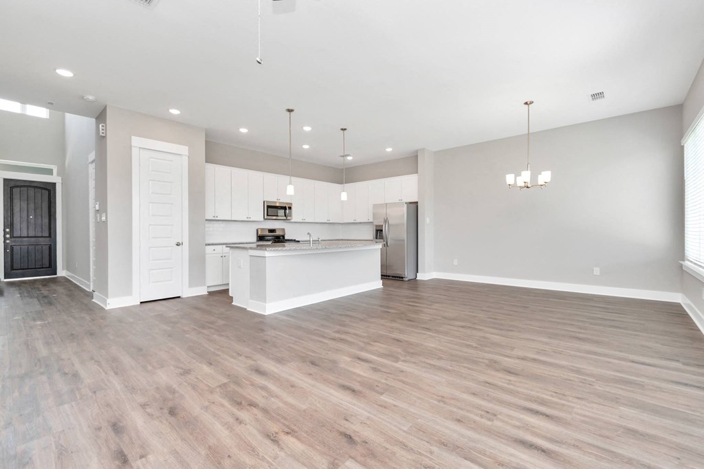 the living room and kitchen in a 555 waverly unit