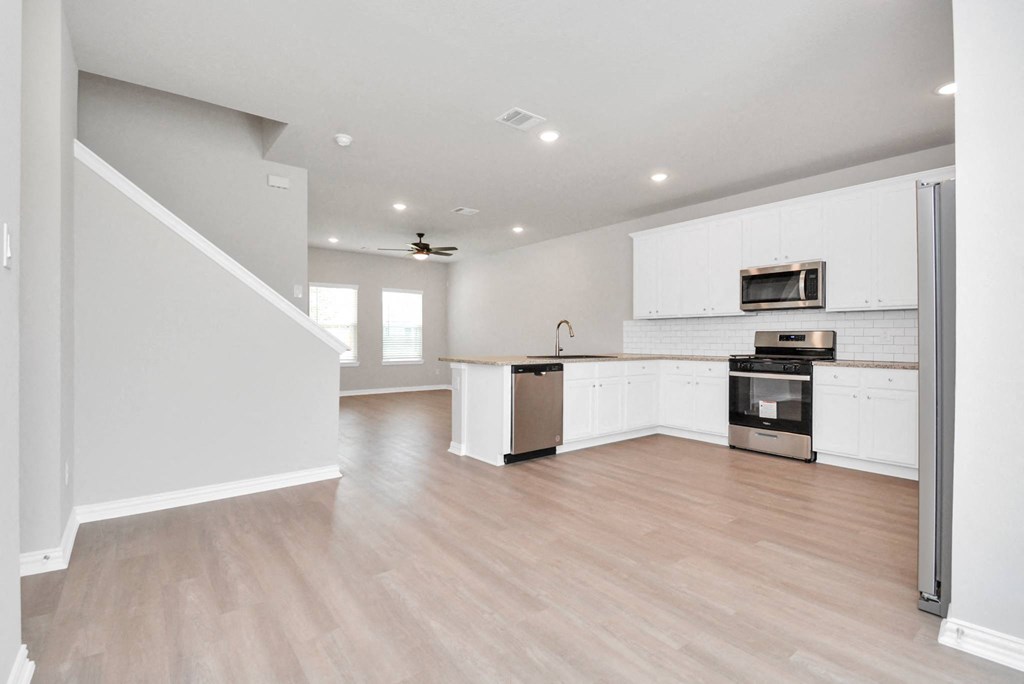 the living room and kitchen in a 555 waverly unit