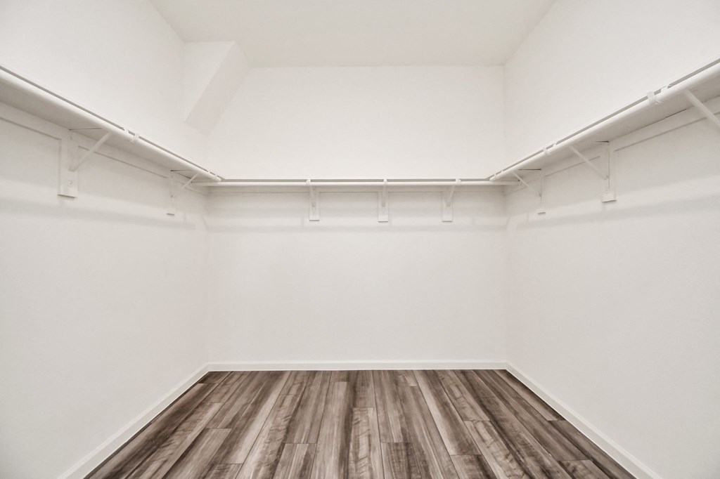 A room with white walls and wooden flooring.