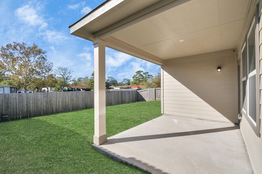 A house with a white porch and a green lawn.