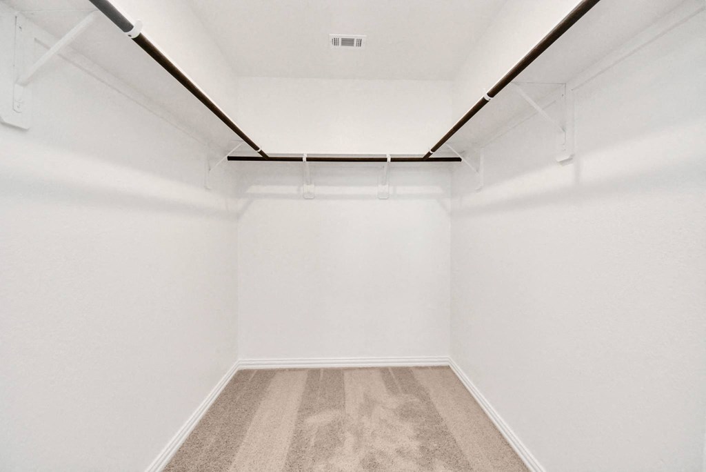 an empty room with white walls and carpet