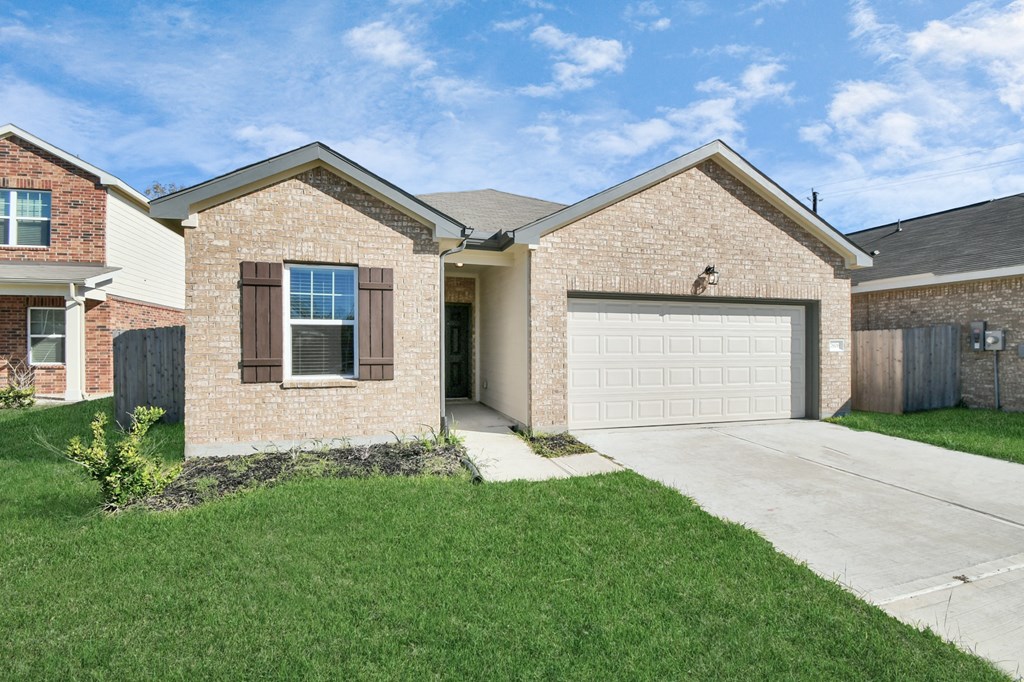 A two-story house with a garage and a driveway.
