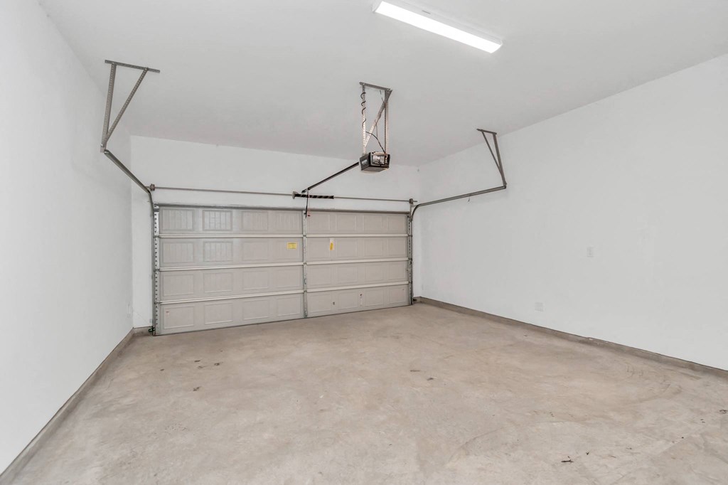 the inside of a garage with a white wall and a white garage door