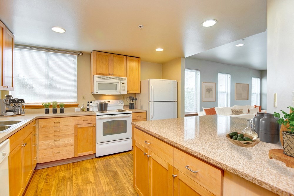 a kitchen with white appliances and wooden cabinets