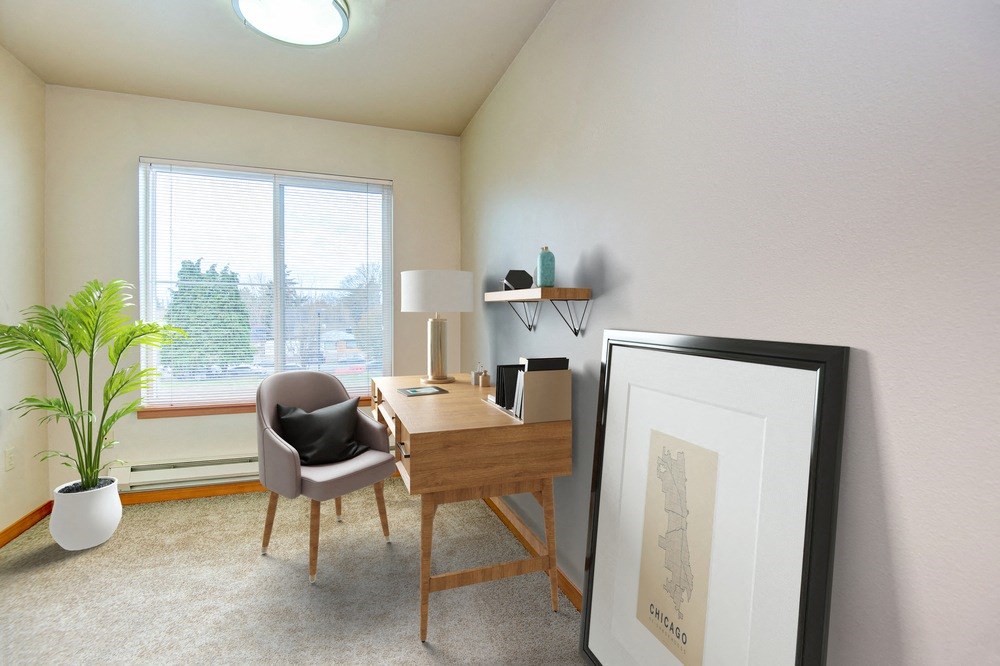 a desk with a chair and a lamp in a room with a large window