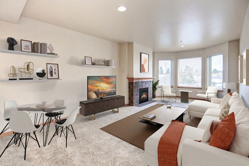 a living room with white couches and chairs and a coffee table in front of a fireplace - Photo Gallery