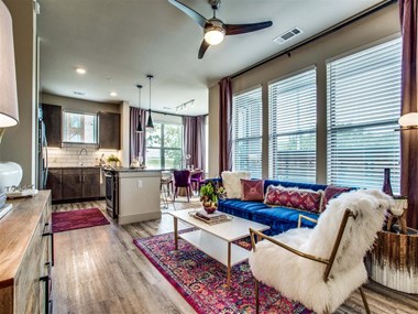 Grand Prairie TX Apartments - Living Room Area With Hardwood Style Floors, Chic Decor and Access to Kitchen & Dining Areas