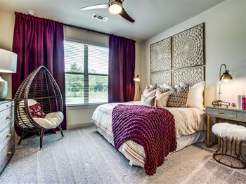 One Two and Three Bedroom Apartments in Grand Prairie, TX - Bedroom With Lush Carpeting, Large Window and Stylish Decor - Photo Gallery 2