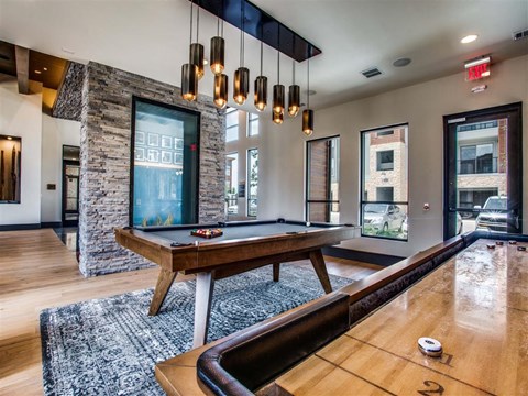 a game room with a pool table and a window